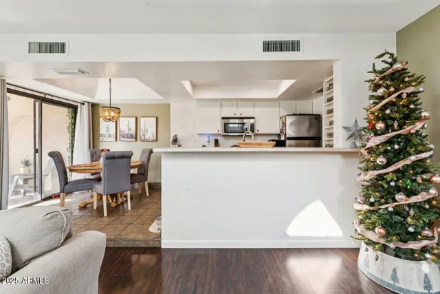 a kitchen with stainless steel appliances a stove a sink a refrigerator a window