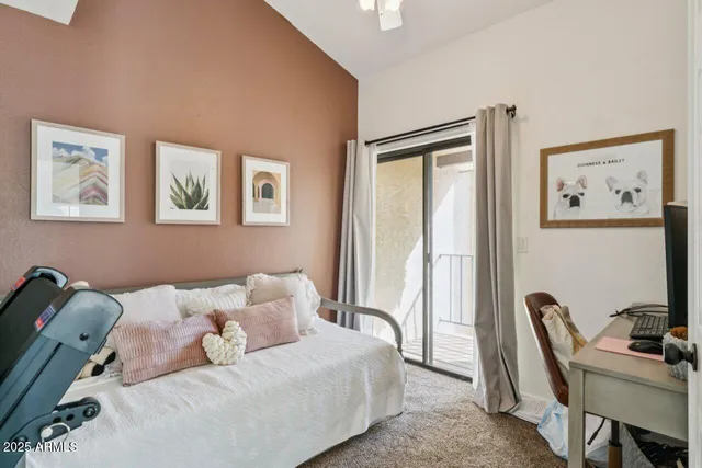 a bedroom with furniture and a flat screen tv