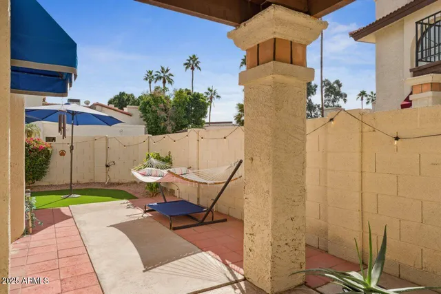 a view of a backyard with furniture and a garden