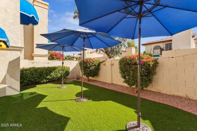 a view of an chairs and table in the backyard
