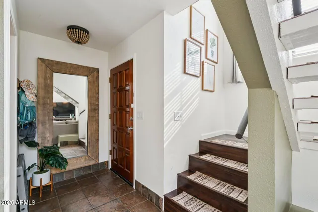 a living room with furniture a large window and a flat screen tv
