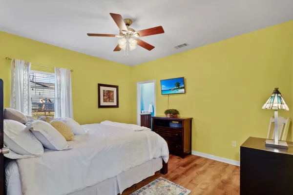 a bedroom with a bed and a window