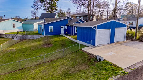 a view of a house with a swimming pool and a yard