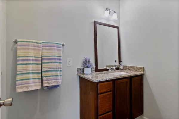 a backyard of a house with a garden and barbeque oven