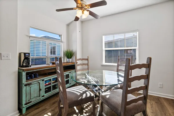 a large kitchen with kitchen island a large counter top and stainless steel appliances