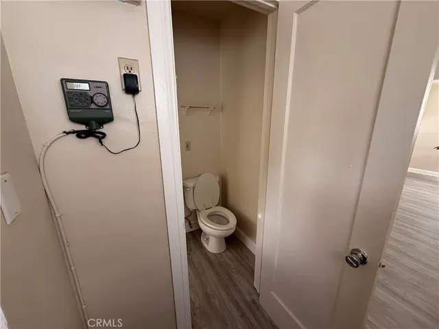 a view of a big room with wooden floor and windows