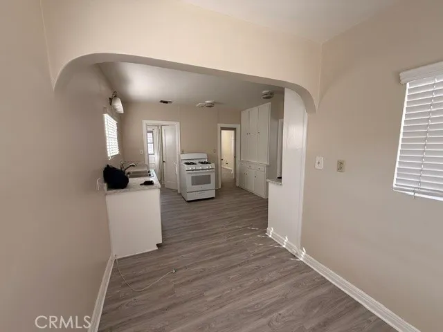 a kitchen with granite countertop a stove and a sink