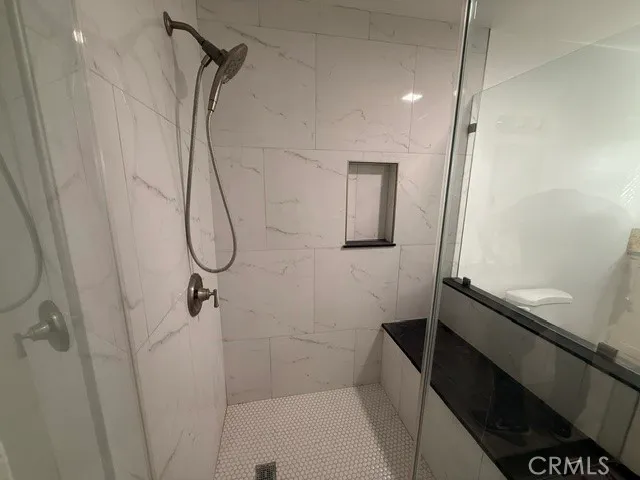 a view of a room with wooden floor and bathroom