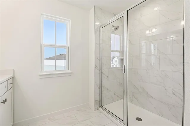 a bathroom with a glass shower door