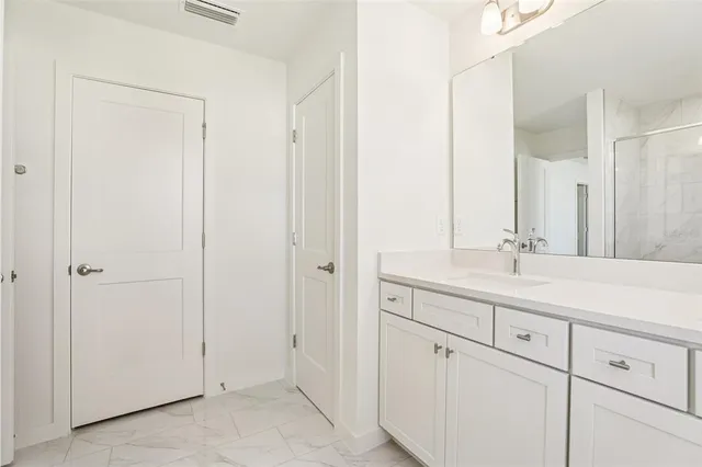 a bathroom with a double vanity sink and mirror