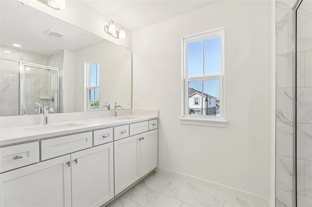 a bathroom with 2 sink and a mirror