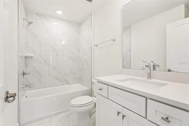 a bathroom with a sink a toilet and a bathtub