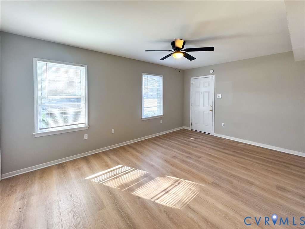 1706 Hungary Road Henrico, VA 23228 - Photo 20 of 28 a view of an empty room with wooden floor and a window