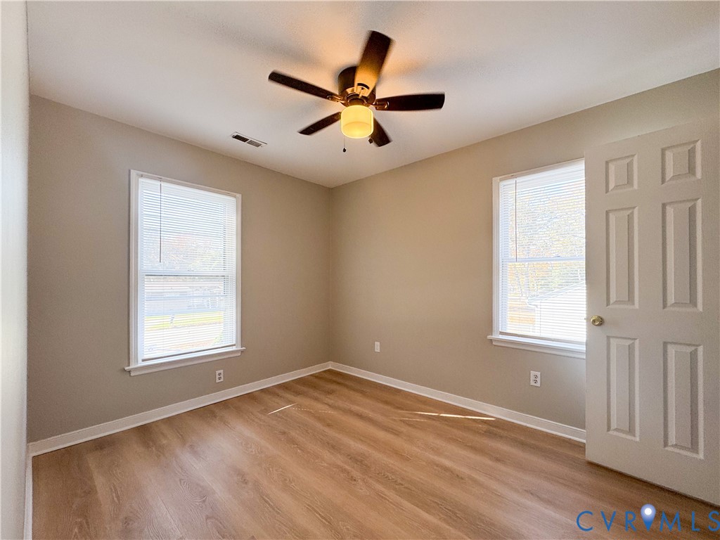 1706 Hungary Road Henrico, VA 23228 - Photo 7 of 28 a view of an empty room with wooden floor and a window