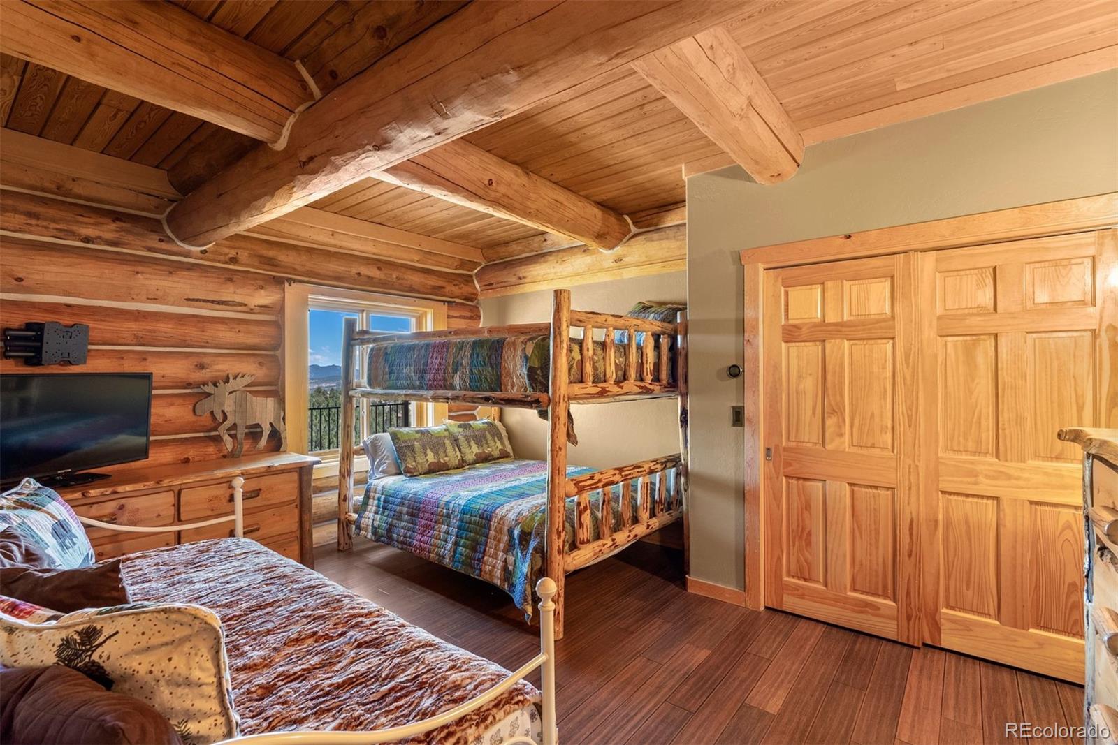 217 North Hill Drive Bailey, CO 80421 - Photo 32 of 49 a bedroom with furniture and a wooden floor