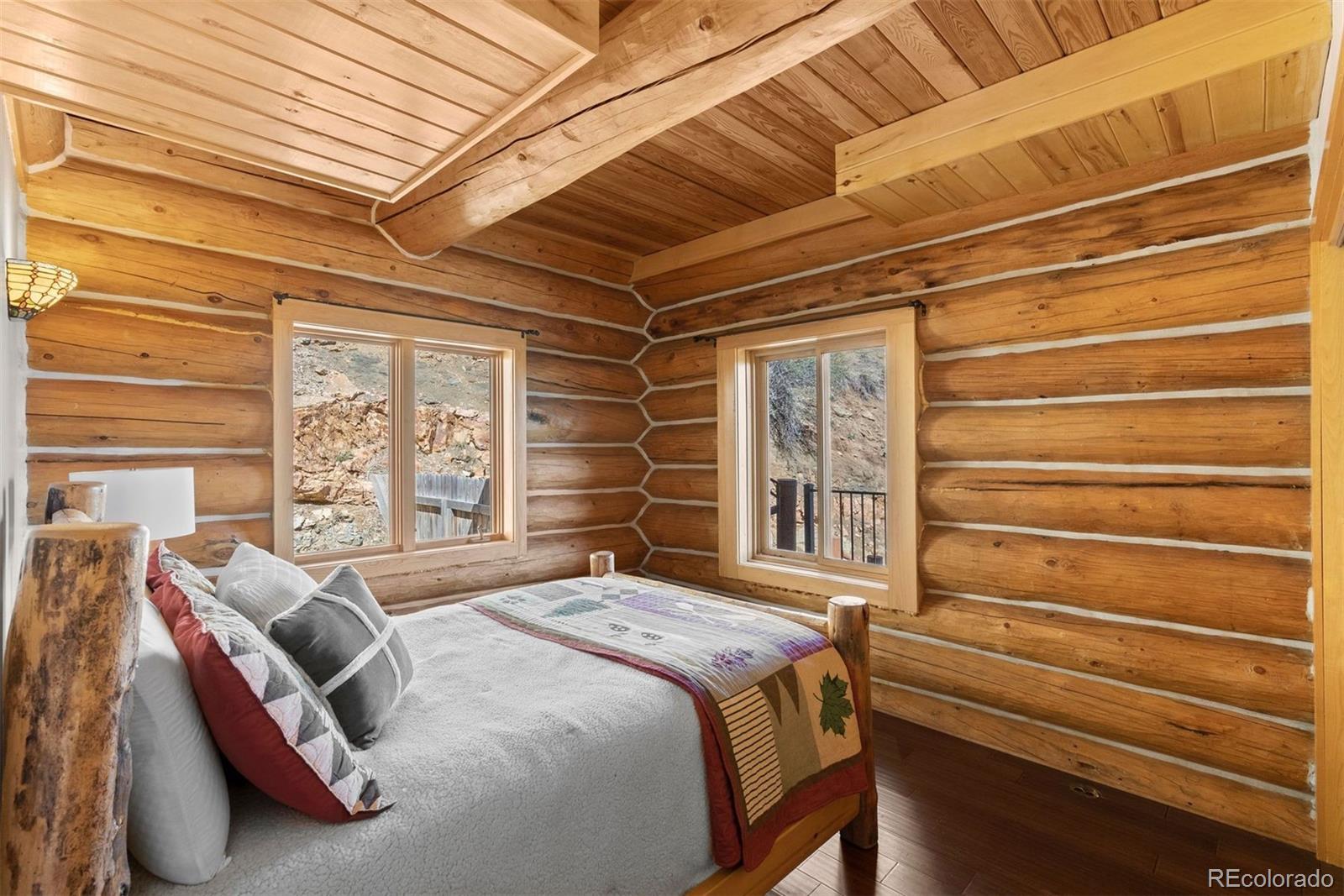 217 North Hill Drive Bailey, CO 80421 - Photo 33 of 49 a bed sitting in a bedroom next to a window