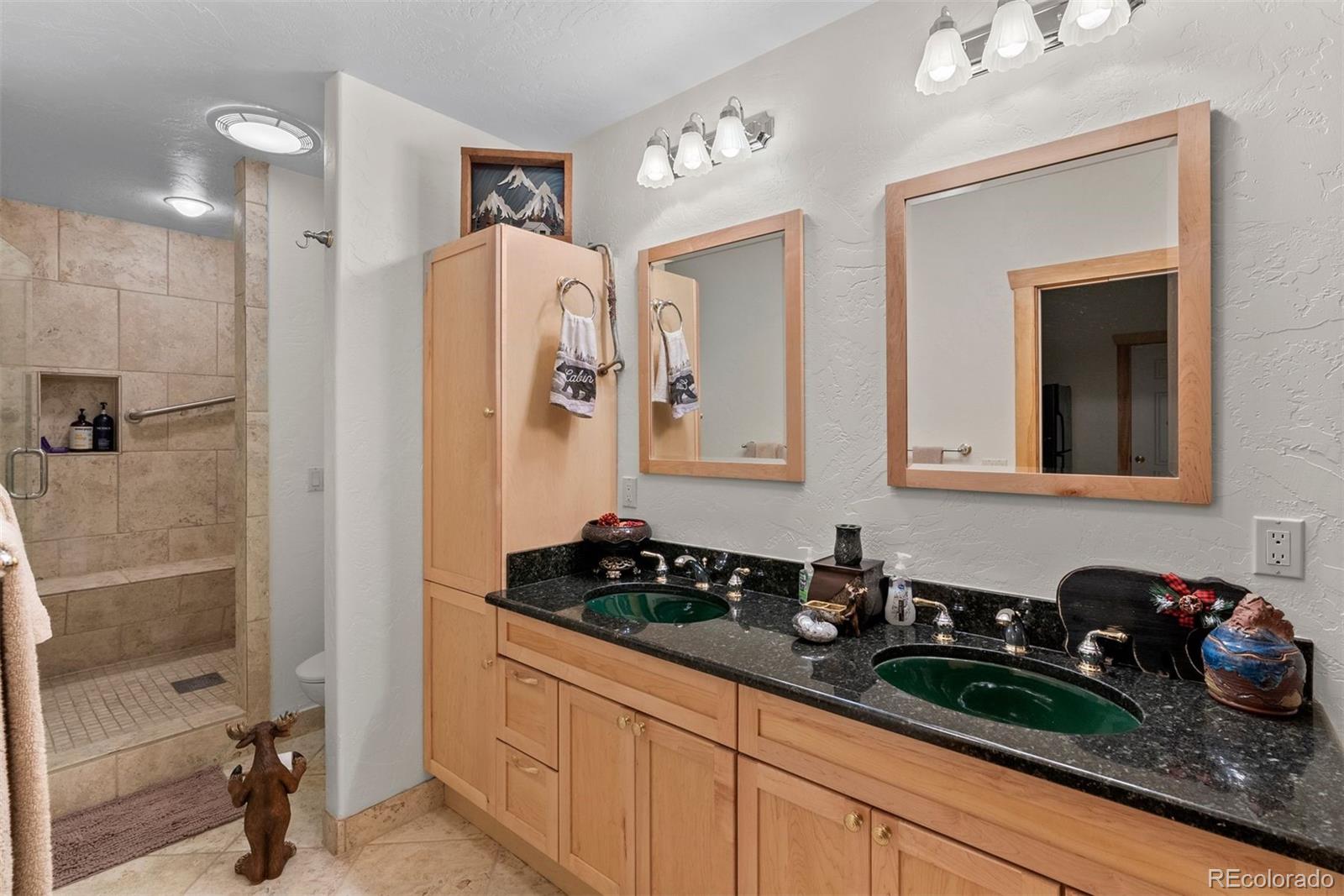 217 North Hill Drive Bailey, CO 80421 - Photo 39 of 49 a bathroom with a sink and a mirror