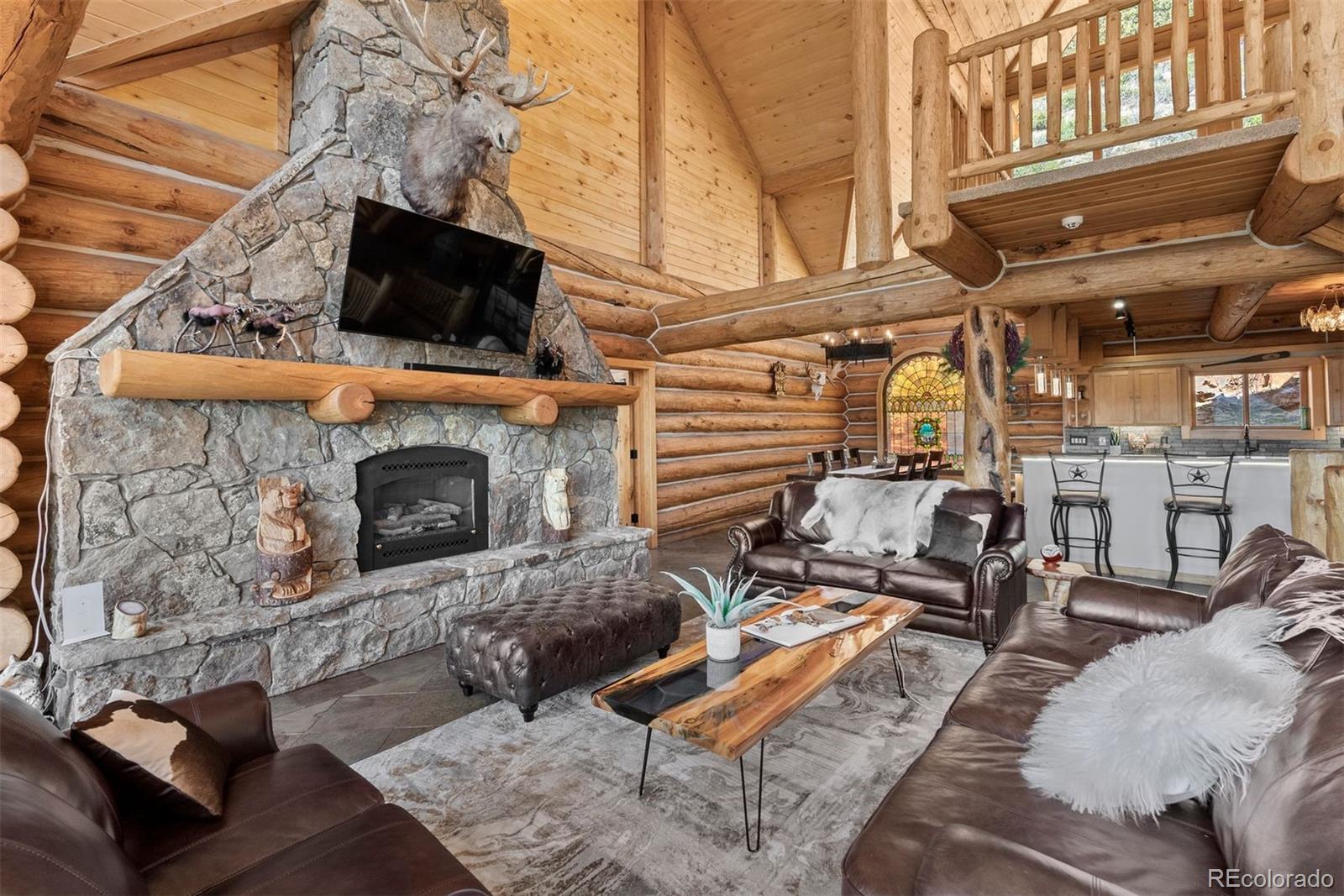 217 North Hill Drive Bailey, CO 80421 - Photo 9 of 49 a view of a couch with wooden deck