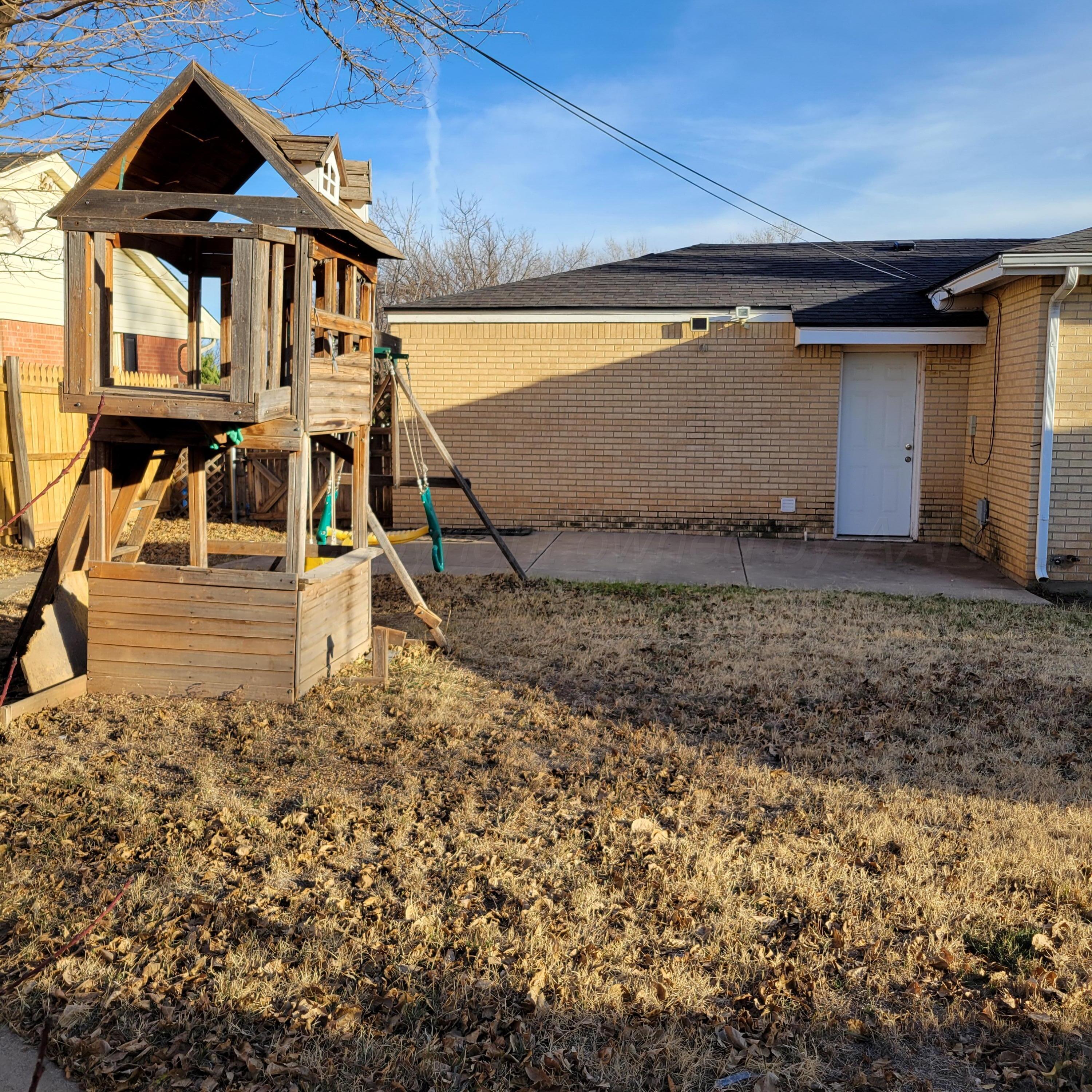 1806 Chama Street Amarillo, TX 79102 - Photo 13 of 15 a front view of a house with a yard