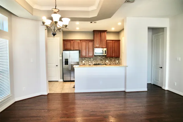a view of a kitchen with a refrigerator and a microwave