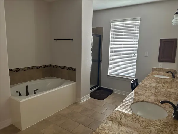 a bath tub sitting in a bathroom next to a window