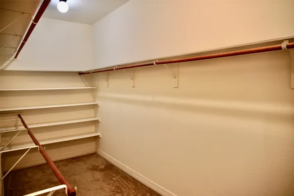 a spacious bathroom with a tub sink and mirror