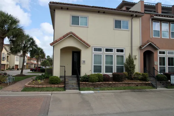 a front view of a house with a yard and a garage
