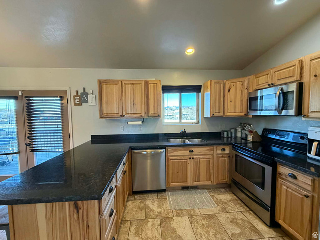 2095 West 4100 North Spring Glen, UT 84526 - Photo 4 of 35 Kitchen with stainless steel appliances, a peninsula, dark stone counters, lofted ceiling, and recessed lighting