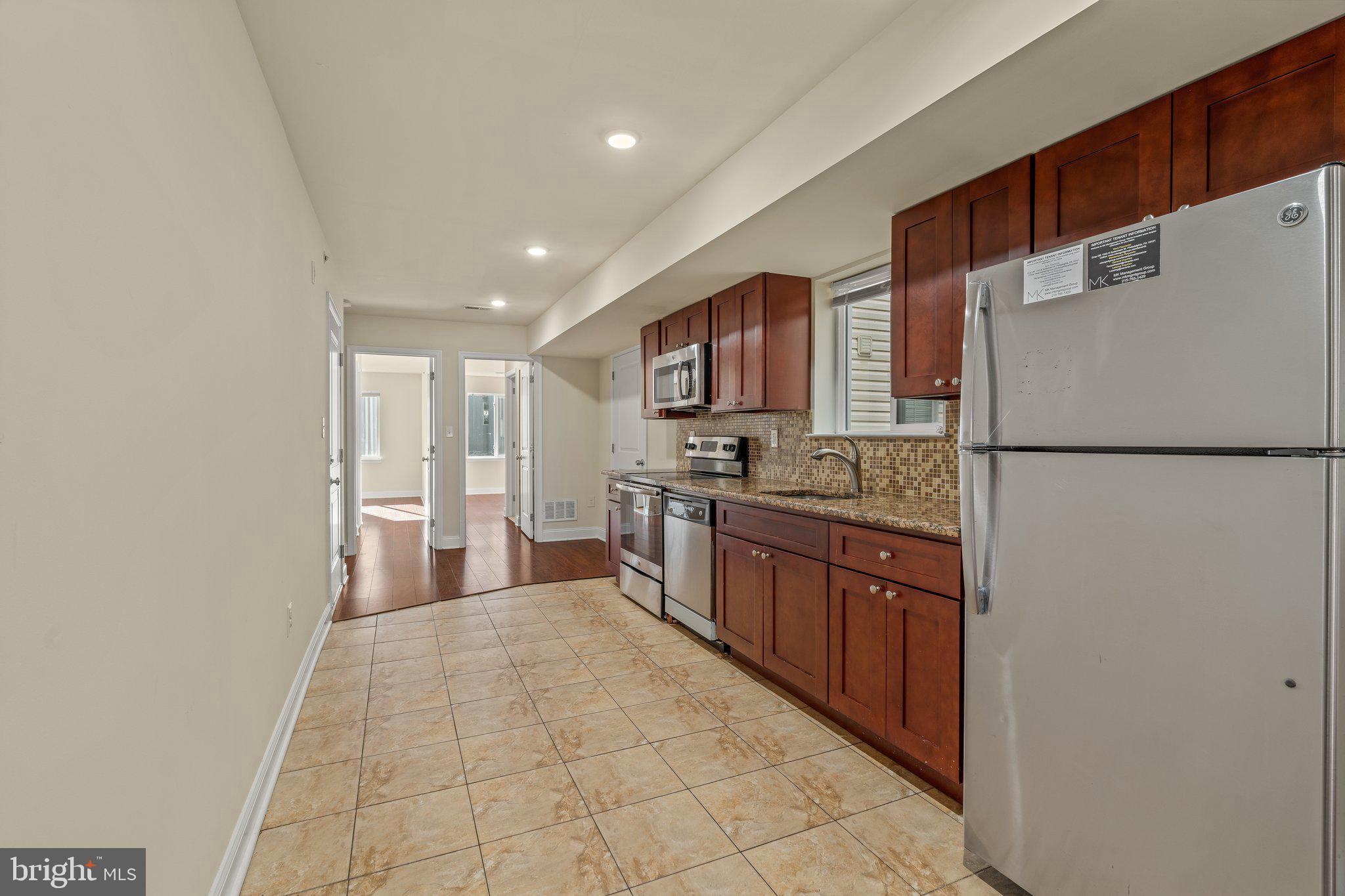 1724 Master Street, Unit C Philadelphia, PA 19121 - Photo 17 of 24 a large kitchen with a refrigerator and a stove