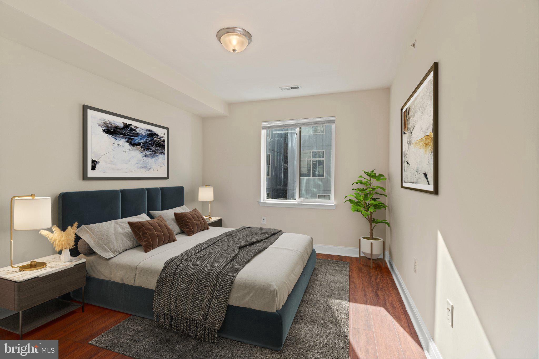 1724 Master Street, Unit C Philadelphia, PA 19121 - Photo 20 of 24 a bedroom with bed and a painting on the wall
