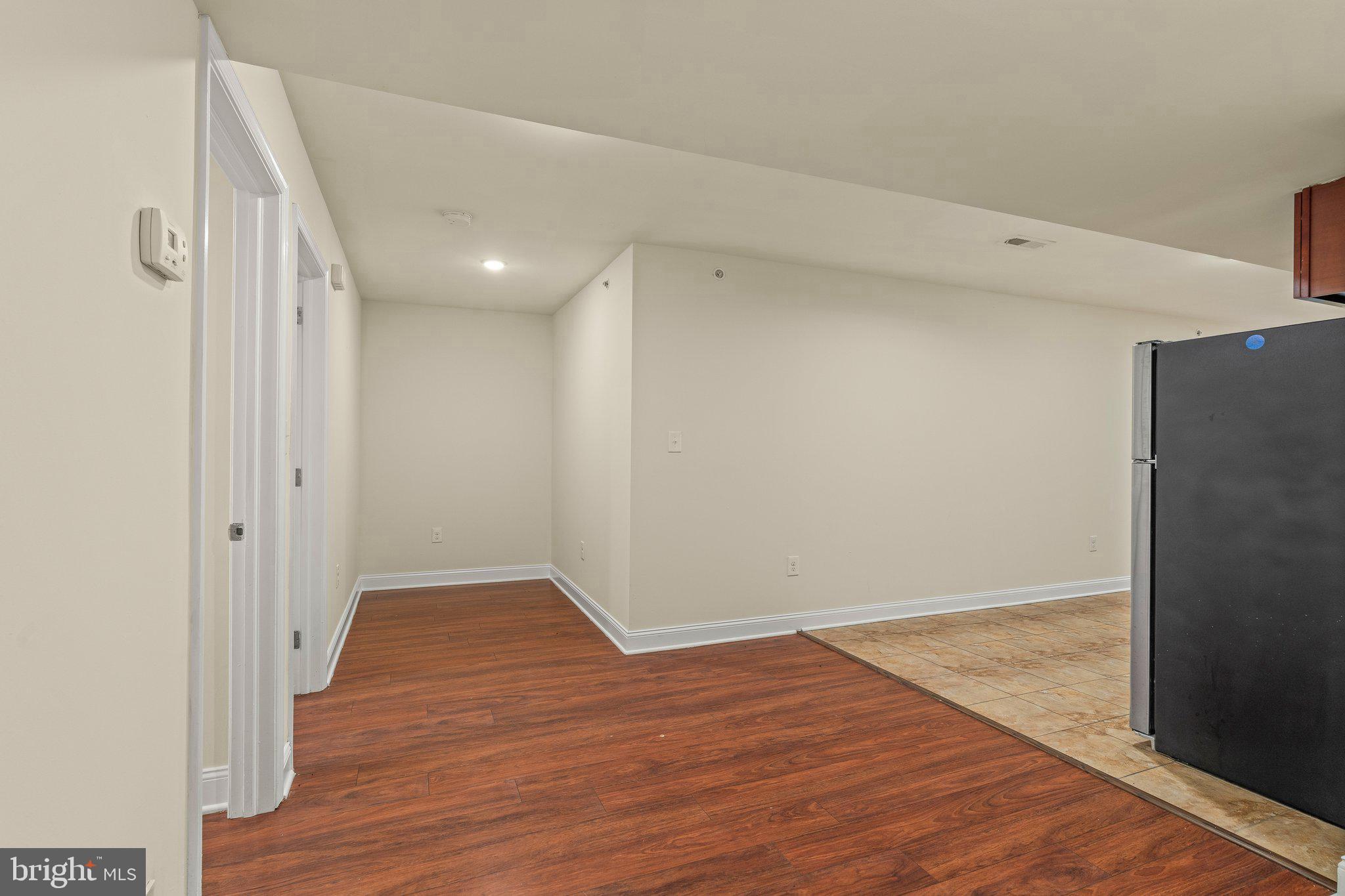 1724 Master Street, Unit C Philadelphia, PA 19121 - Photo 4 of 24 a view of an empty room with wooden floor and a bathroom