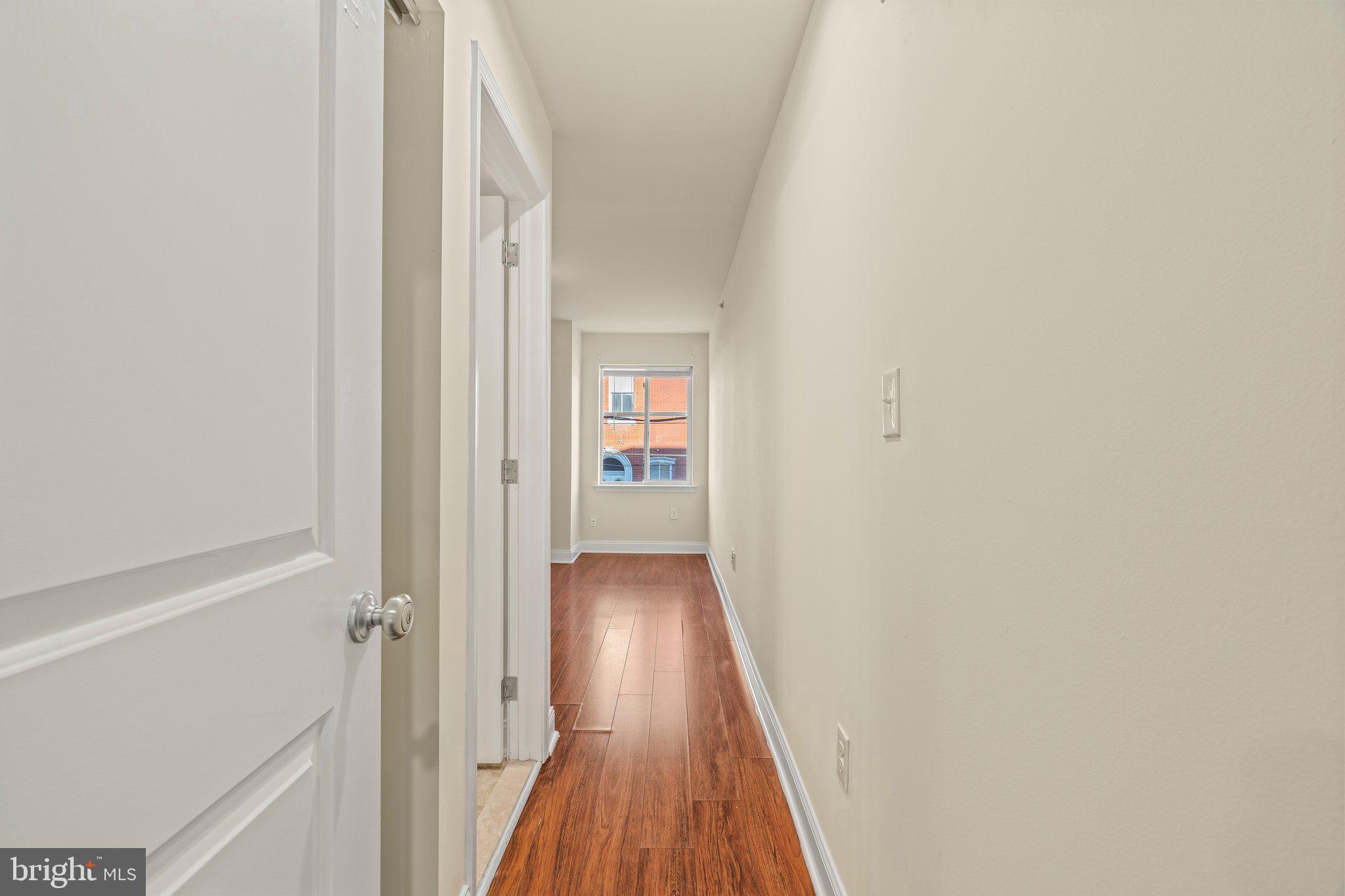 1724 Master Street, Unit C Philadelphia, PA 19121 - Photo 5 of 24 a view of a hallway with wooden floor and staircase