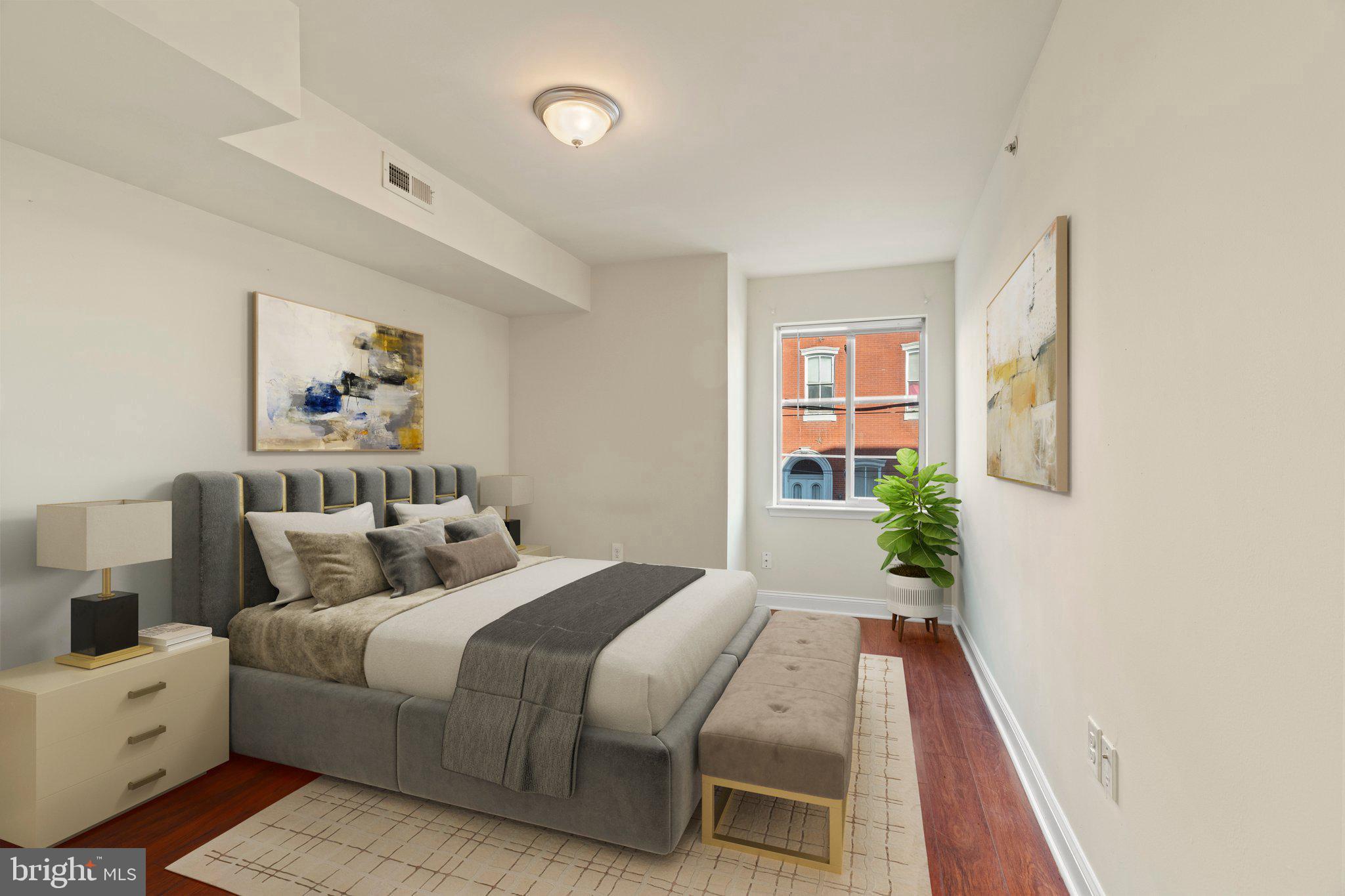 1724 Master Street, Unit C Philadelphia, PA 19121 - Photo 6 of 24 a bed room with a bed and a painting on the wall