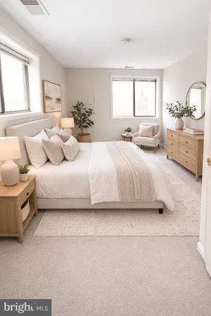 a bedroom with a bed a double vanity and window