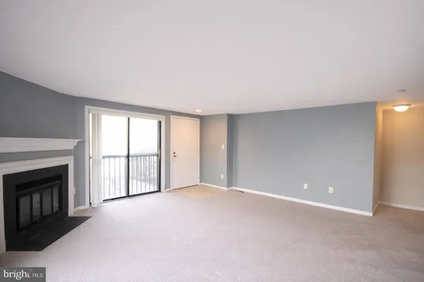 a view of an empty room with a fireplace
