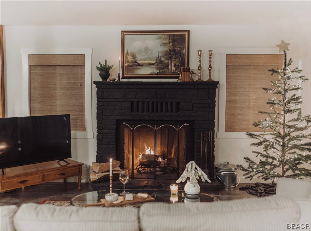 42897 Encino Road Big Bear Lake, CA 92315 - Photo 1 of 45 a living room with furniture a flat screen tv and a fireplace