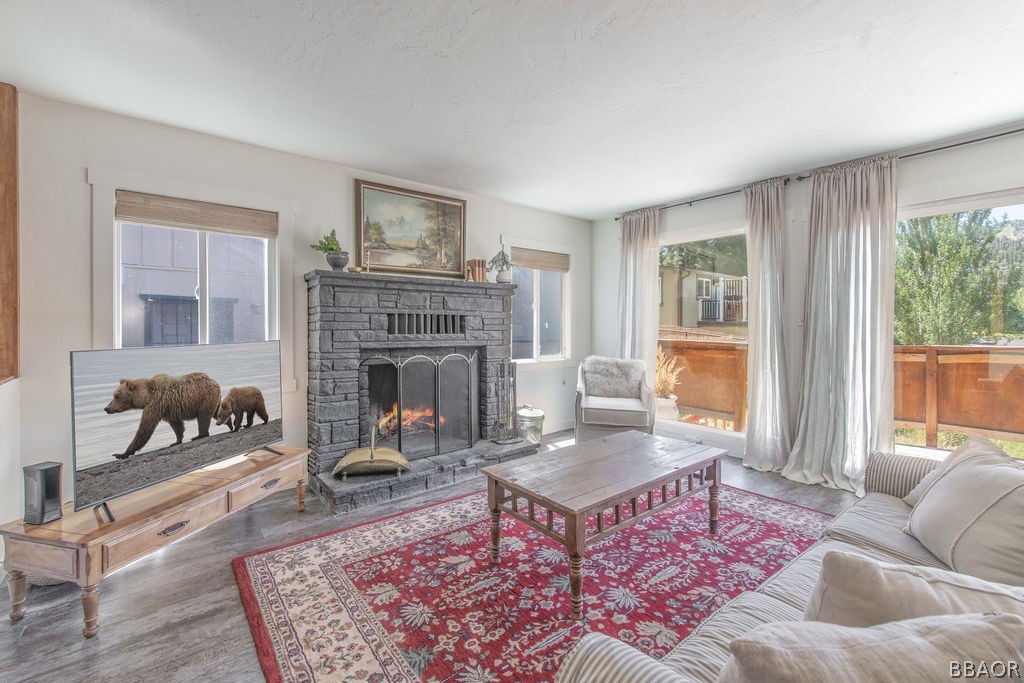 42897 Encino Road Big Bear Lake, CA 92315 - Photo 22 of 45 a living room with furniture and a fireplace