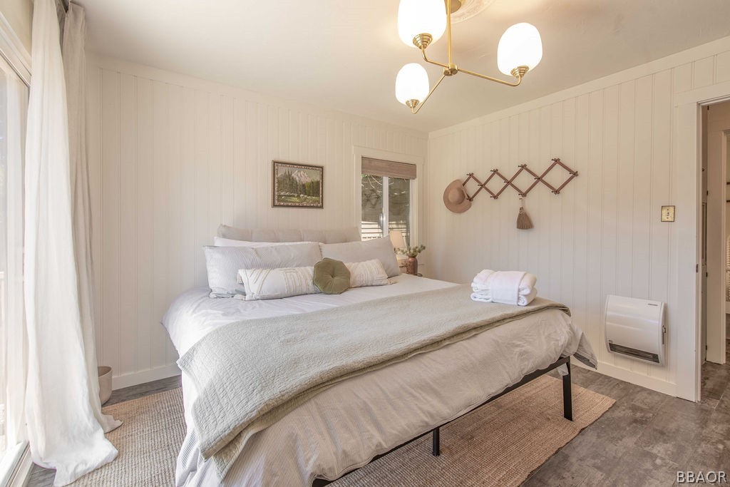 42897 Encino Road Big Bear Lake, CA 92315 - Photo 31 of 45 a bedroom with a bed and a chandelier