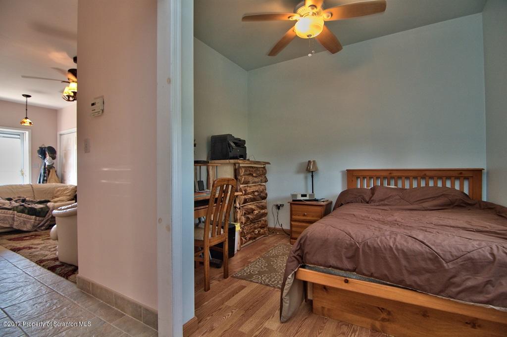 2325 Aberdeen Road Moscow, PA 18444 - Photo 11 of 43 a bedroom with a bed and a chandelier