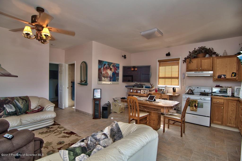 2325 Aberdeen Road Moscow, PA 18444 - Photo 6 of 43 a living room with furniture a chandelier and a flat screen tv