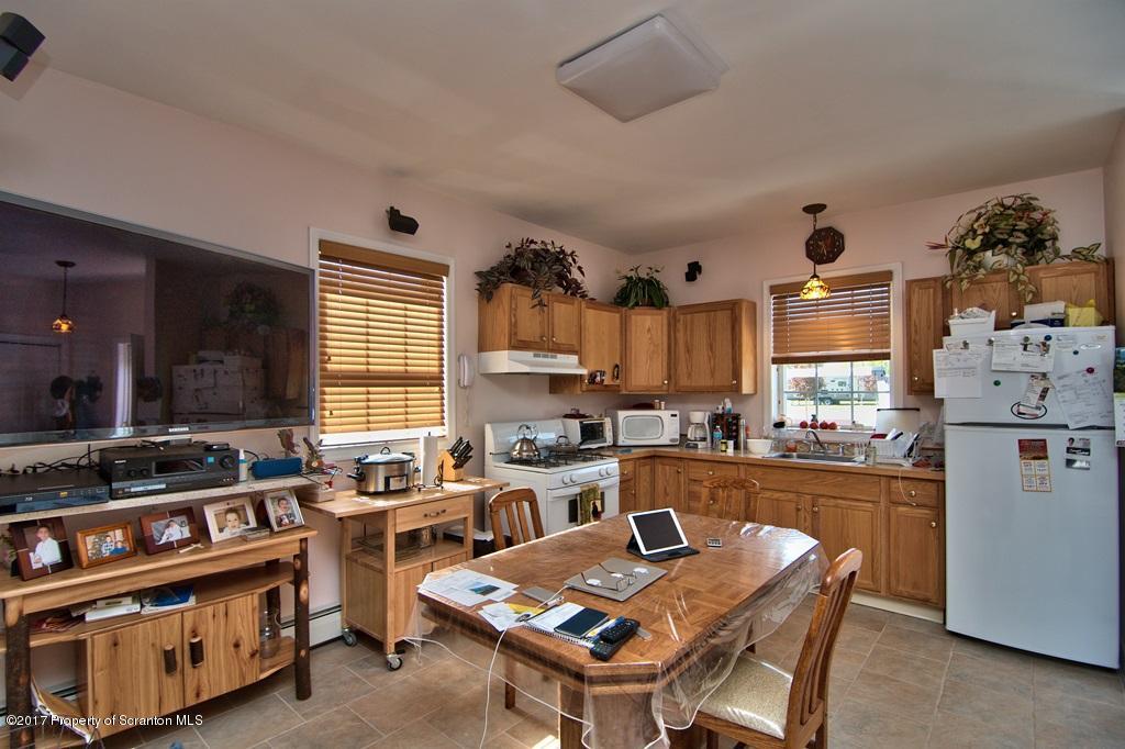 2325 Aberdeen Road Moscow, PA 18444 - Photo 8 of 43 a kitchen with stainless steel appliances granite countertop a stove a sink dishwasher and a refrigerator with wooden floor