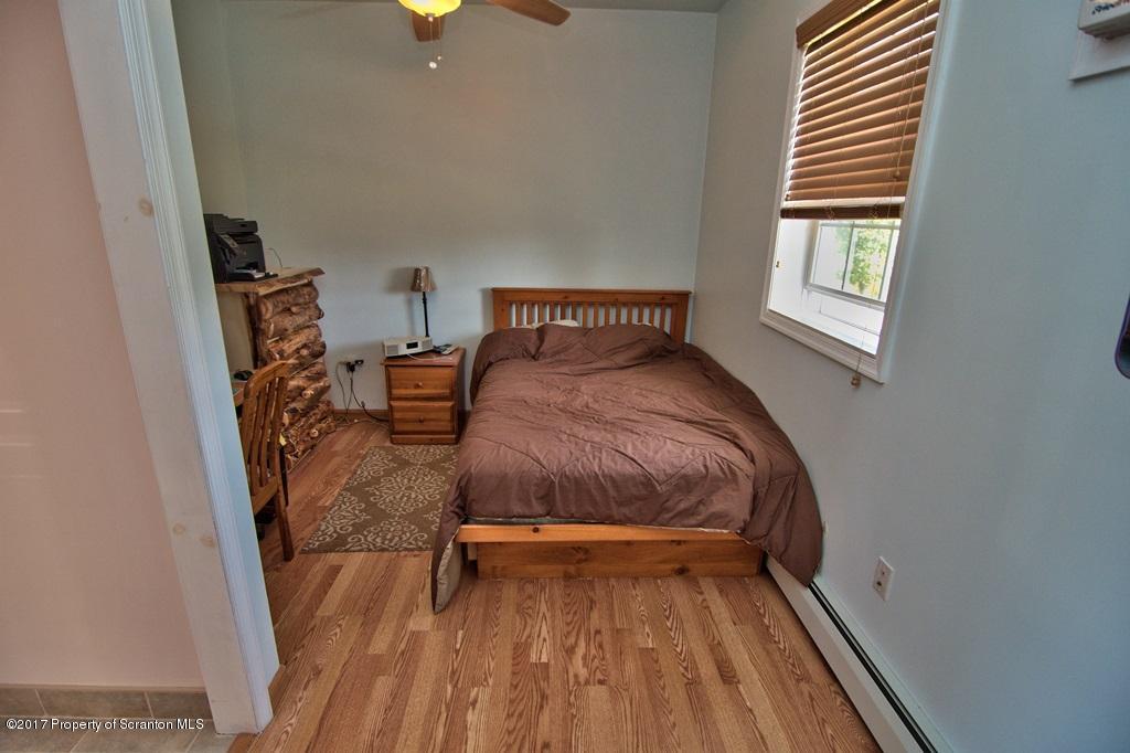 2325 Aberdeen Road Moscow, PA 18444 - Photo 10 of 43 a bedroom with a bed and wooden floor