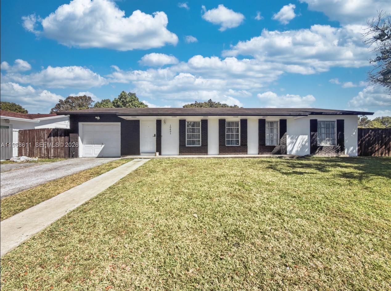 10491 Southwest 122nd Court Miami, FL 33186 - Photo 1 of 25 a front view of house with yard
