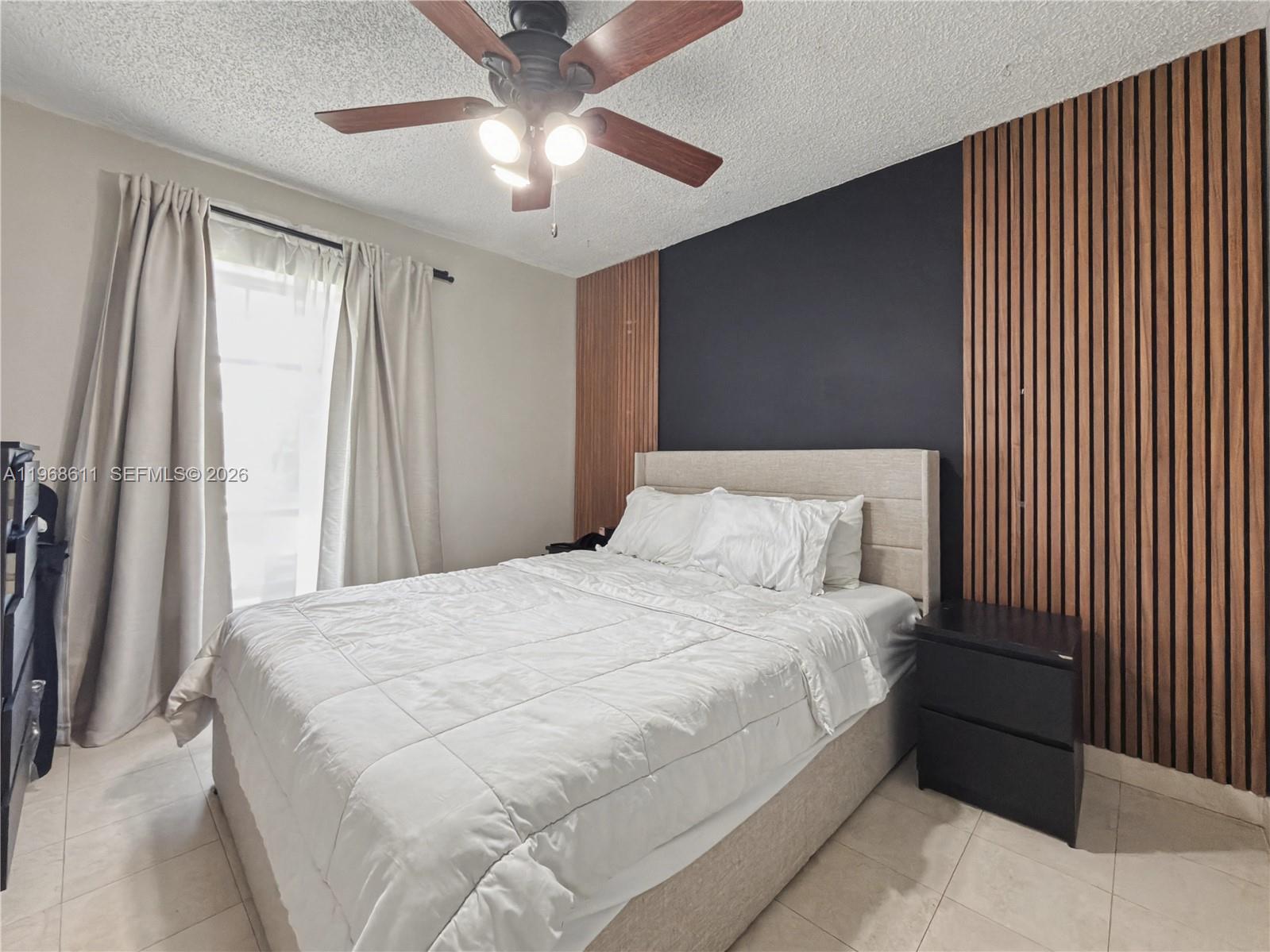 10491 Southwest 122nd Court Miami, FL 33186 - Photo 11 of 25 a large bedroom with a bed and a chandelier