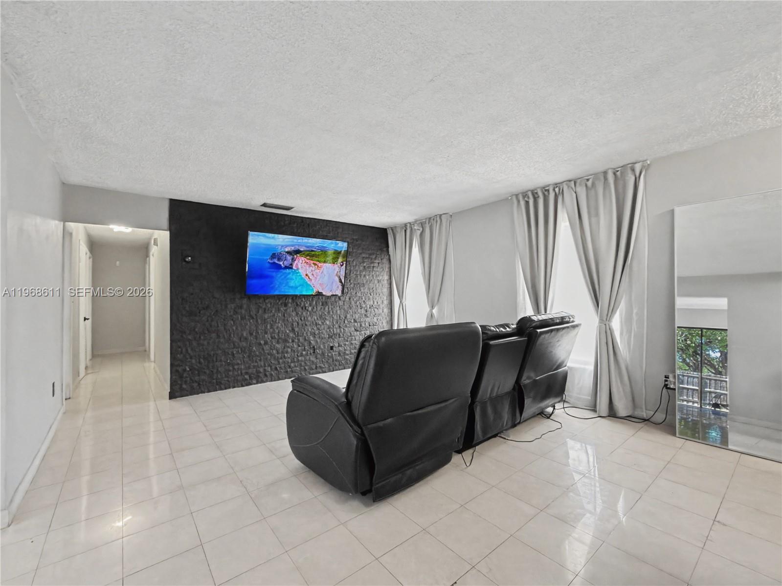 10491 Southwest 122nd Court Miami, FL 33186 - Photo 15 of 25 a living room with furniture and a flat screen tv