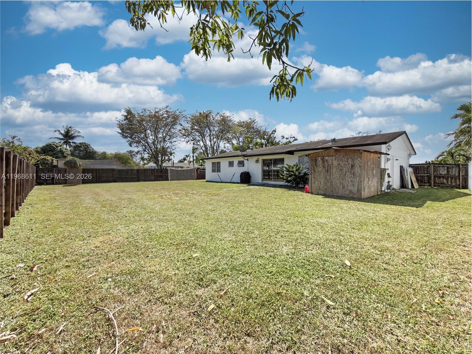 10491 Southwest 122nd Court Miami, FL 33186 - Photo 18 of 25 a view of a house with a yard