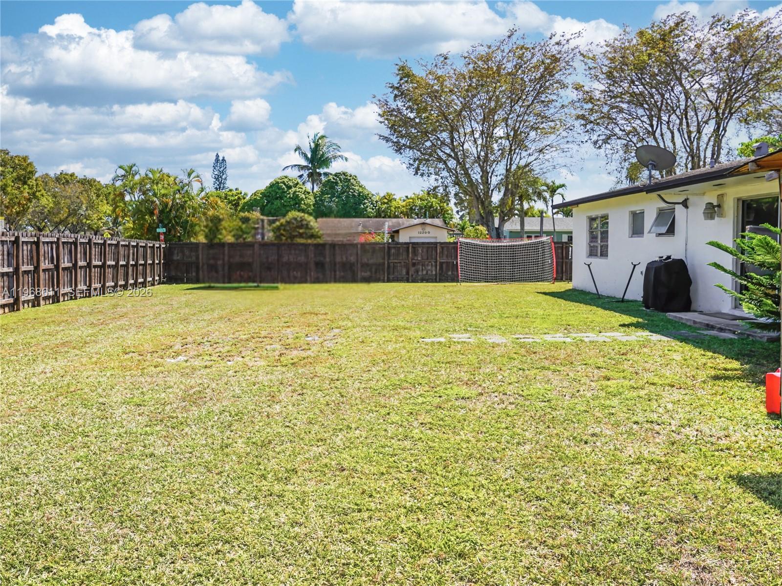 10491 Southwest 122nd Court Miami, FL 33186 - Photo 20 of 25 a swimming pool with trees in front of it