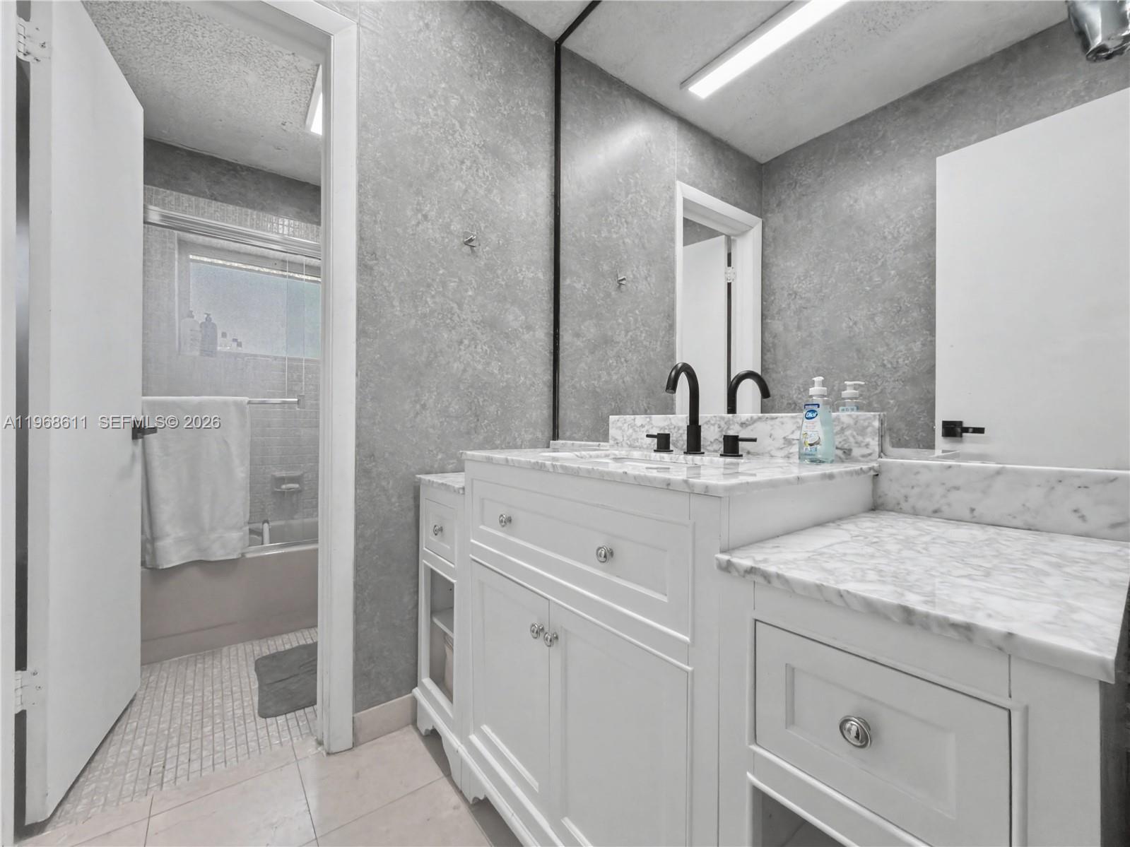 10491 Southwest 122nd Court Miami, FL 33186 - Photo 7 of 25 a bathroom with a granite countertop sink and a mirror