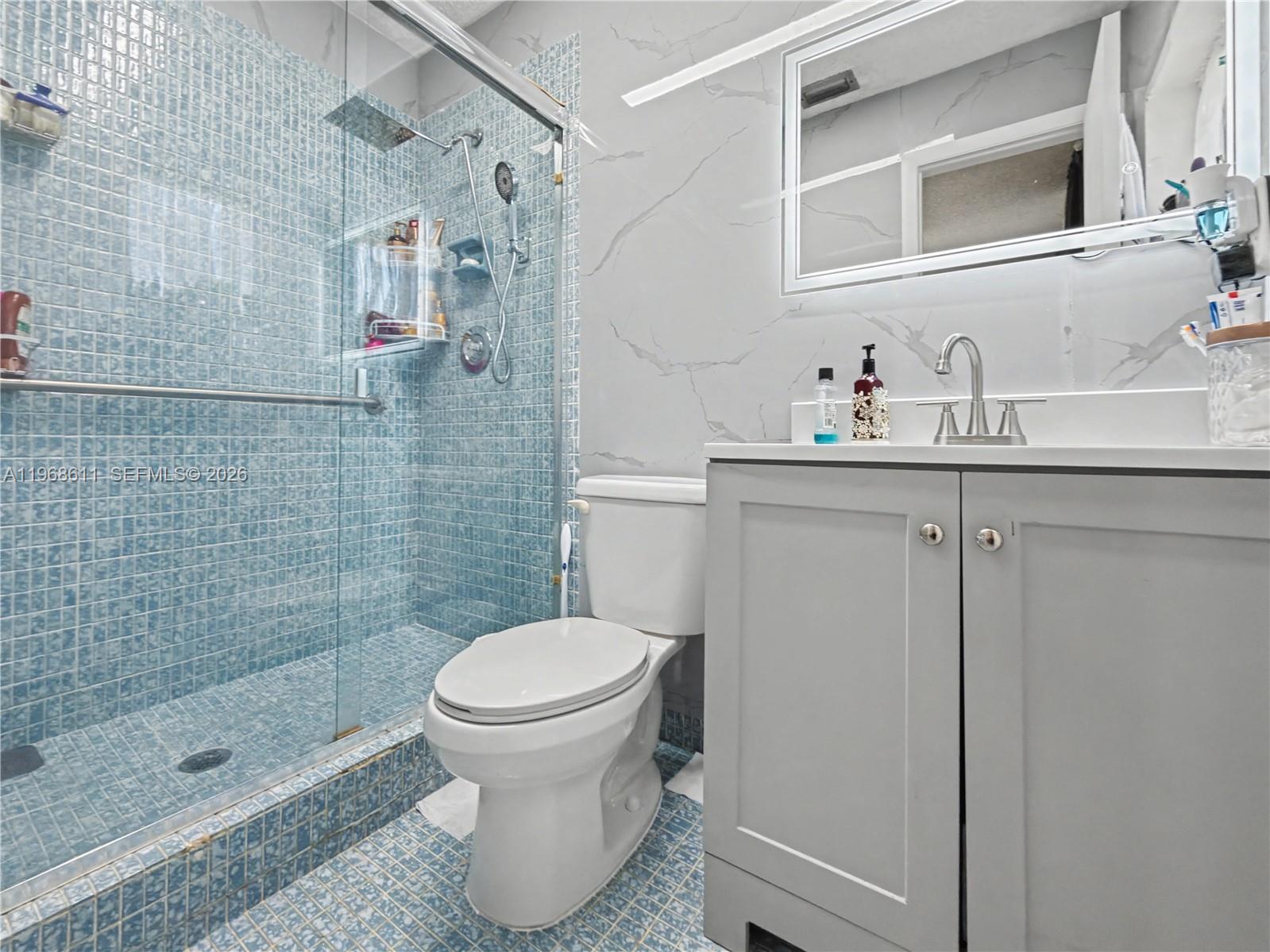 10491 Southwest 122nd Court Miami, FL 33186 - Photo 9 of 25 a bathroom with a sink toilet and shower