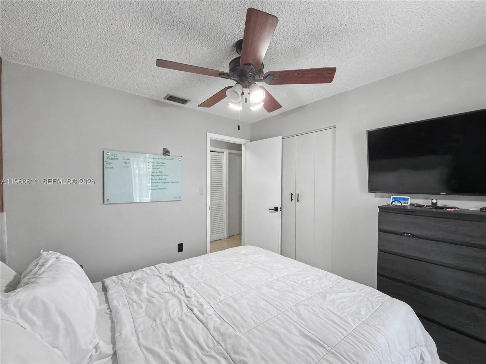 10491 Southwest 122nd Court Miami, FL 33186 - Photo 10 of 25 a bedroom with a bed and a flat screen tv